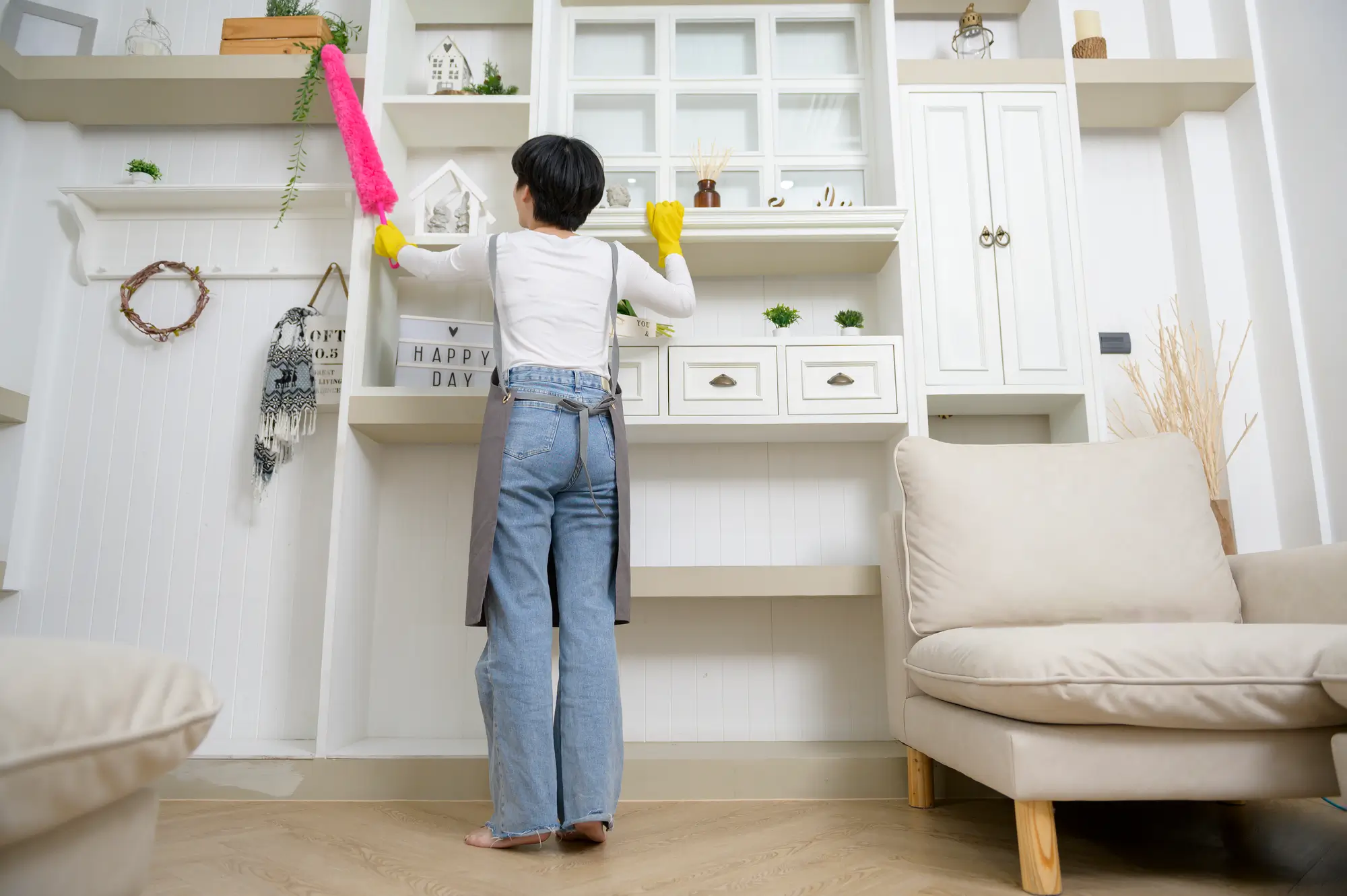 Housekeeper dusting shelves during a regular home cleaning in Castle Rock